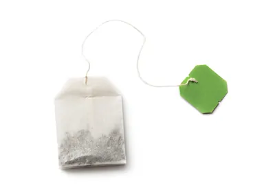 teabag with green tag on a white background